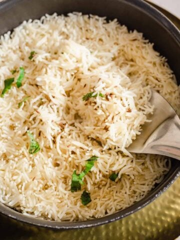 Ghee Rice in a pot with coriander on top