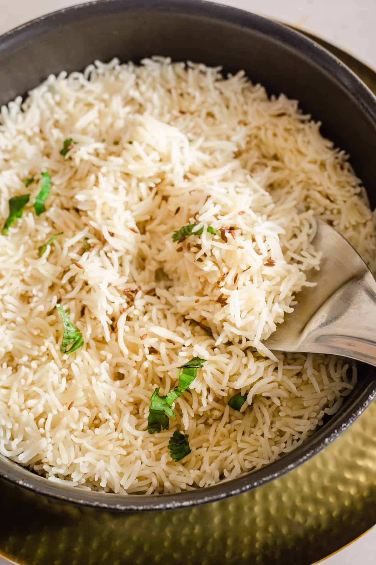 Ghee Rice in a pot with coriander on top