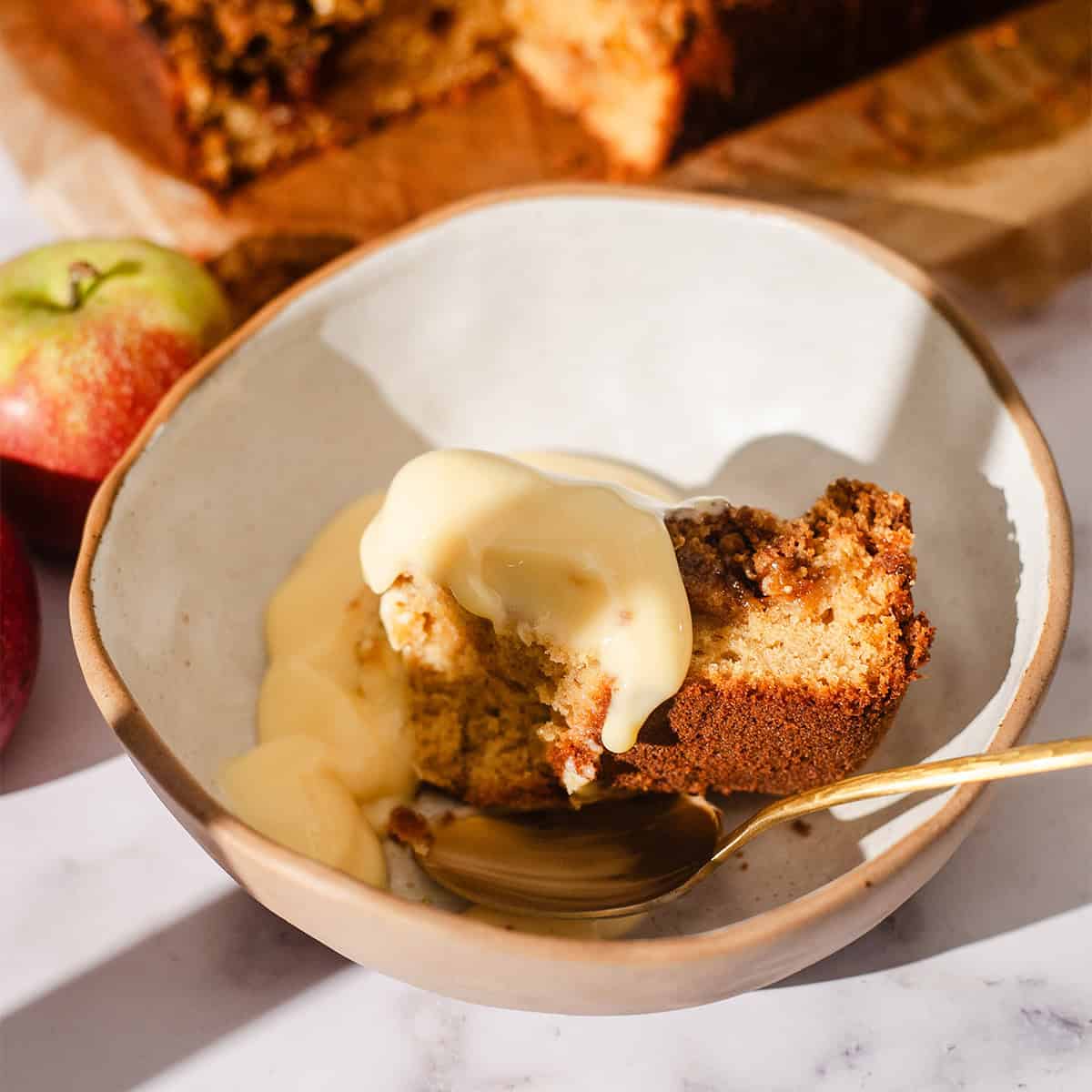 Apple crumble cake and custard in bowl