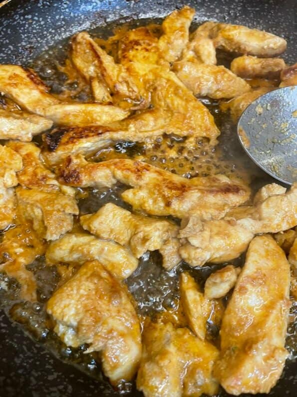 Chicken tikka strips in a pan