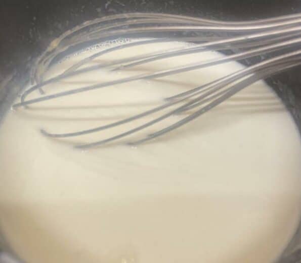 Cheese Sauce being whisked in pot
