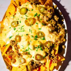 Nachos with cheese sauce on platter