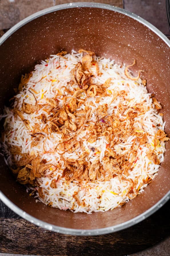 Fried Onions added to Rice in pot