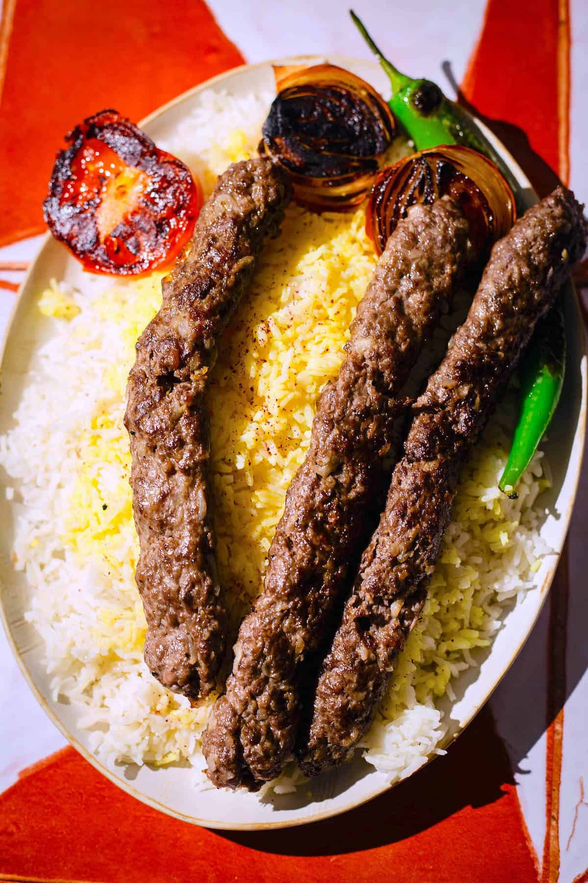 Kebab Koobideh on a platter with rice and vegetables