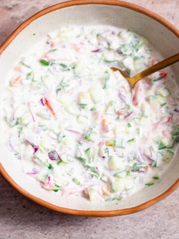 Veg raita in bowl with spoon