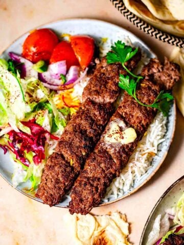 Kebab Koobideh with rice and salad in plate