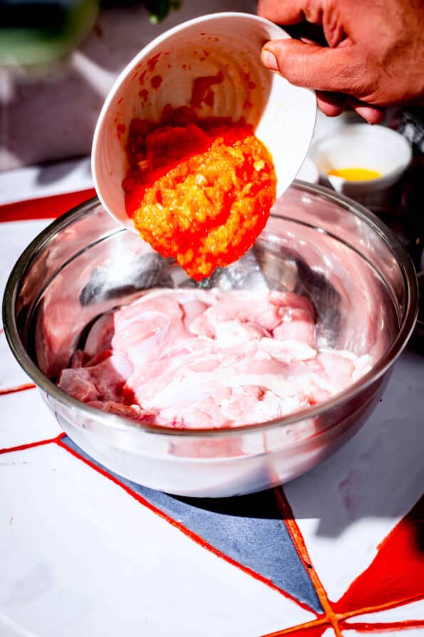 Onion and Tomato paste being added to Chicken