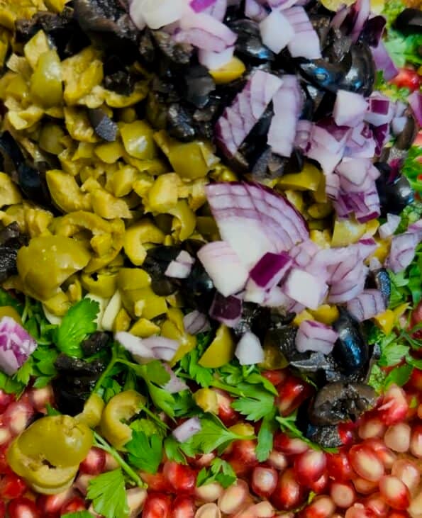 Red Onions and Black Olives added to bowl