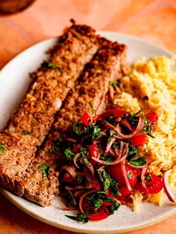 Sheet pan kebab Koobideh with Salad and Rice in plate