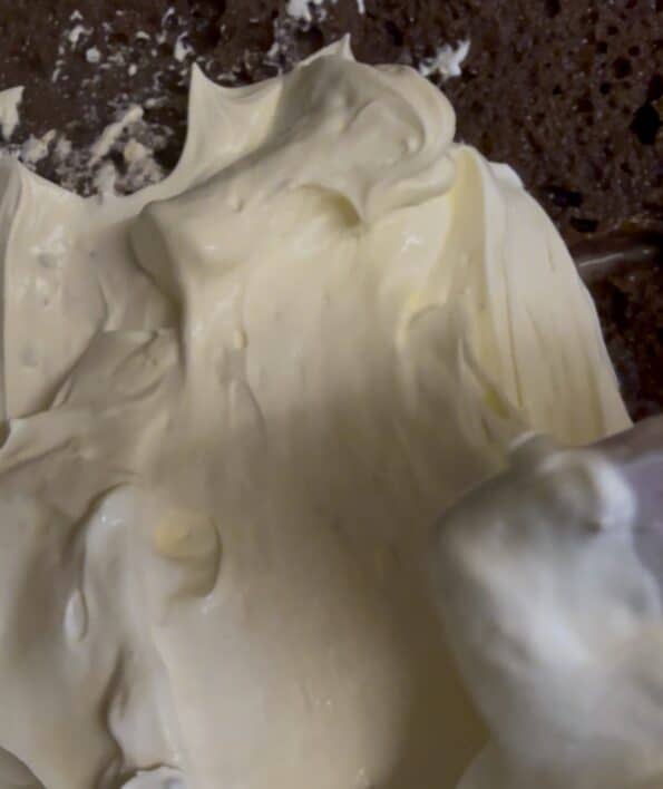 Cream layer being spread on Chocolate Cake layer