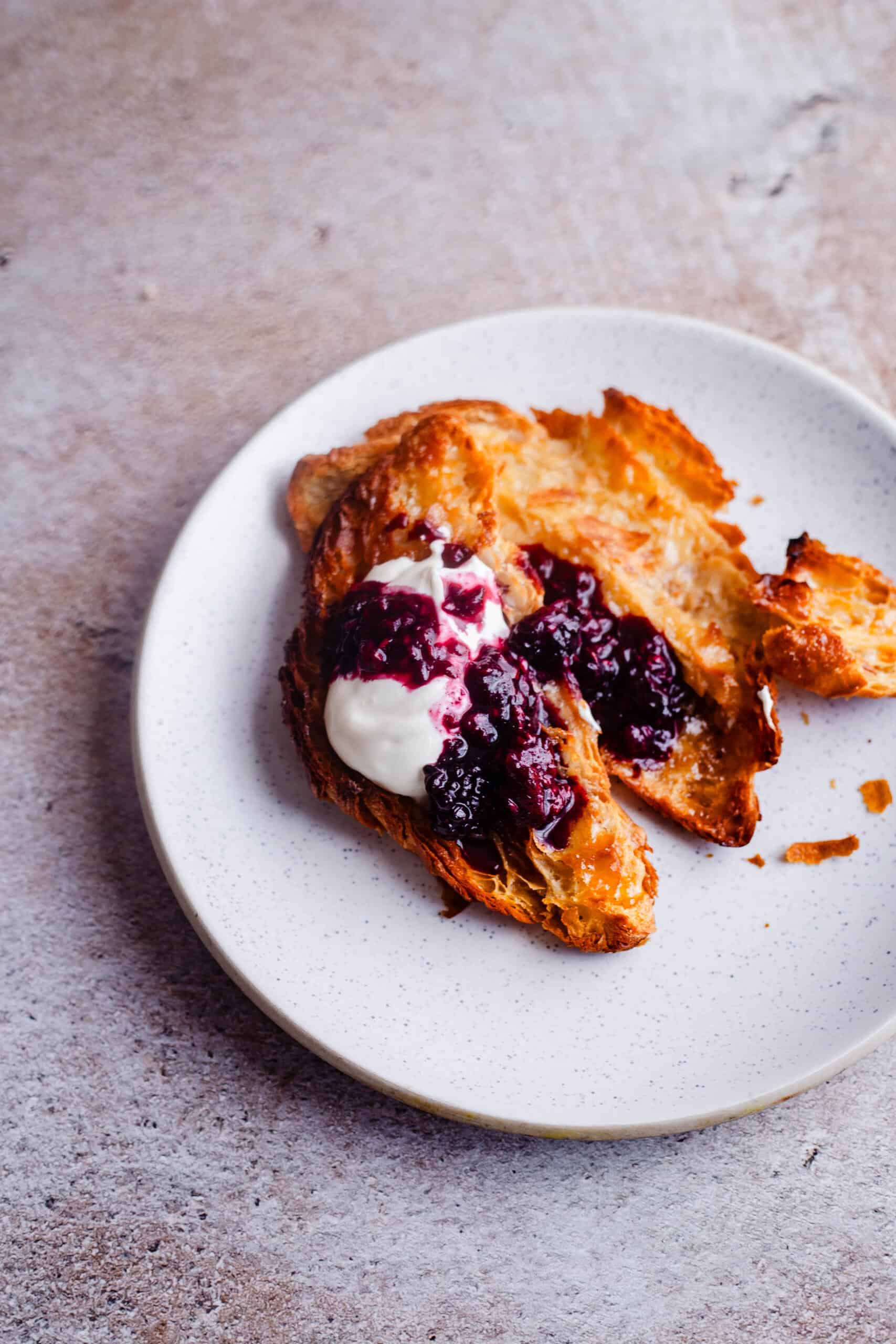 Honey butter croissant in plate with toppings