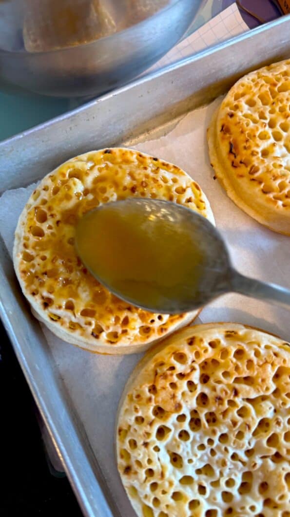 Honey Butter being spread on Crumpets