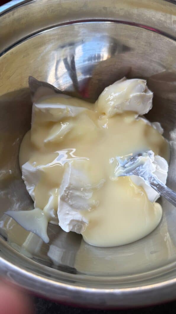 Condensed Milk, cream cheese and cream in bowl