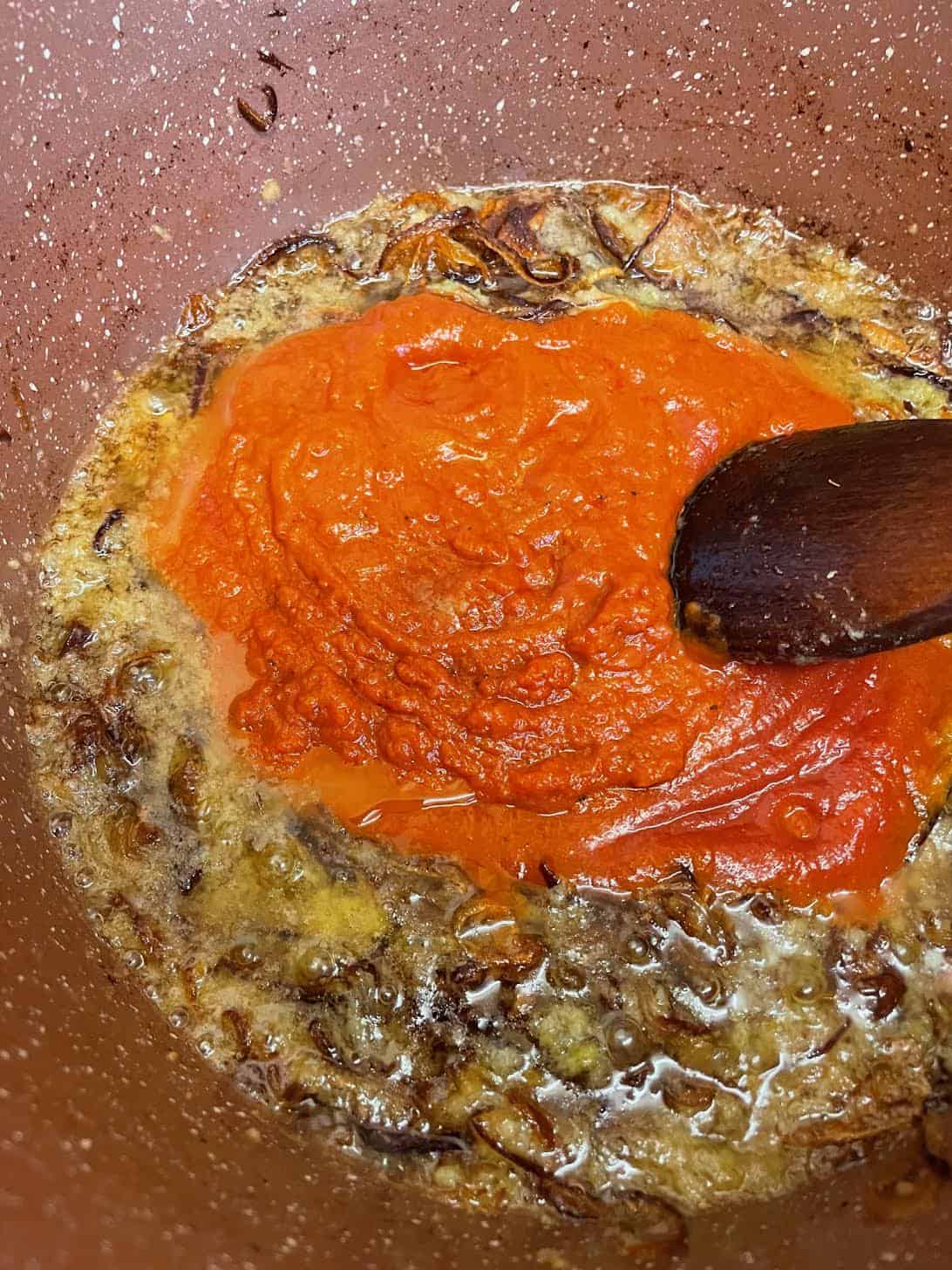 Authentic slow cooked Chicken Haleem Tomatoes added to pot