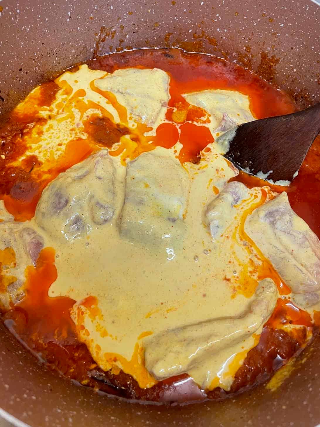 Authentic slow cooked Chicken Haleem Marinaded chicken added to pot