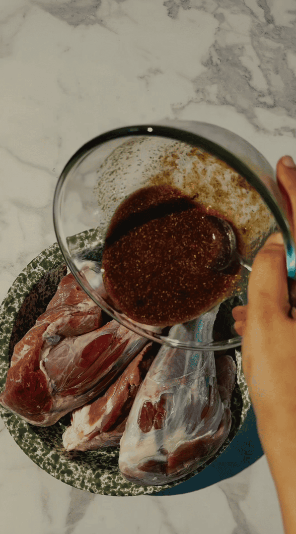 Yemeni Mandi with Lamb Shanks Delicious lamb meat being marinated with tasty spices for authentic Indian tandoori dishes.