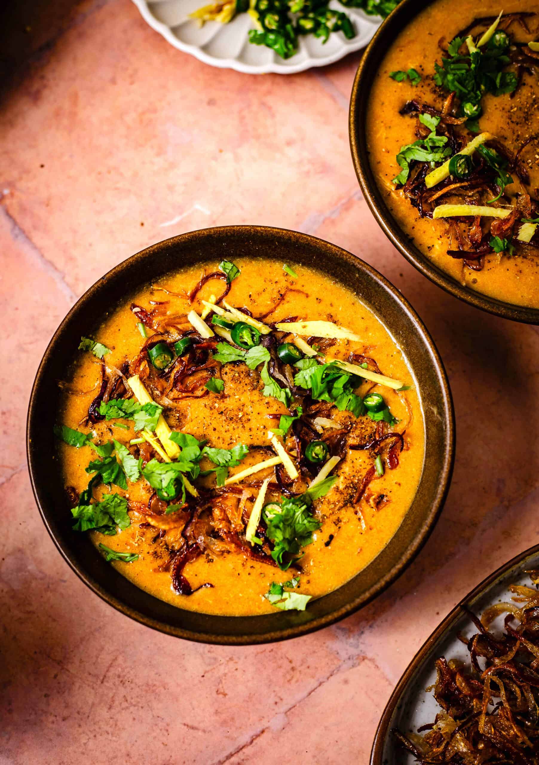 Authentic slow cooked Chicken Haleem Chicken haleem with toppings in bowl