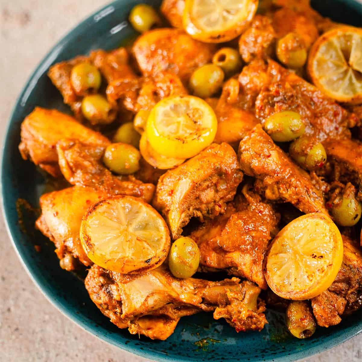Moroccan Chicken Tagine Traybake Chicken tagine in plate with lemons and olives