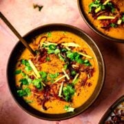 Chicken Haleem in bowl with toppings