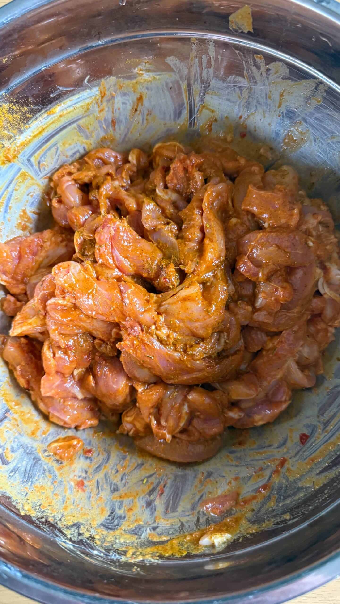 Crispy Chicken Shawarma Wrap with Toum and Pomegranate Molasses Marinaded Chicken pieces in bowl