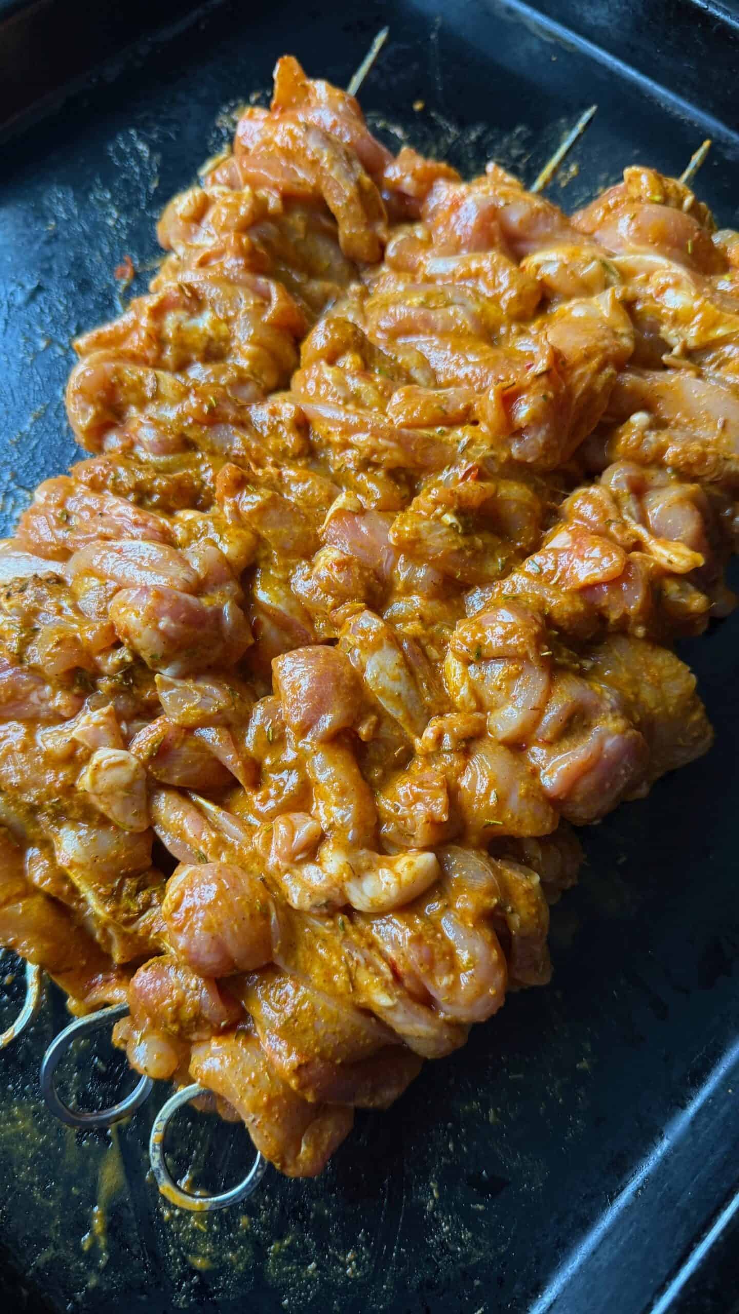 Crispy Chicken Shawarma Wrap with Toum and Pomegranate Molasses Chicken threaded onto skewers