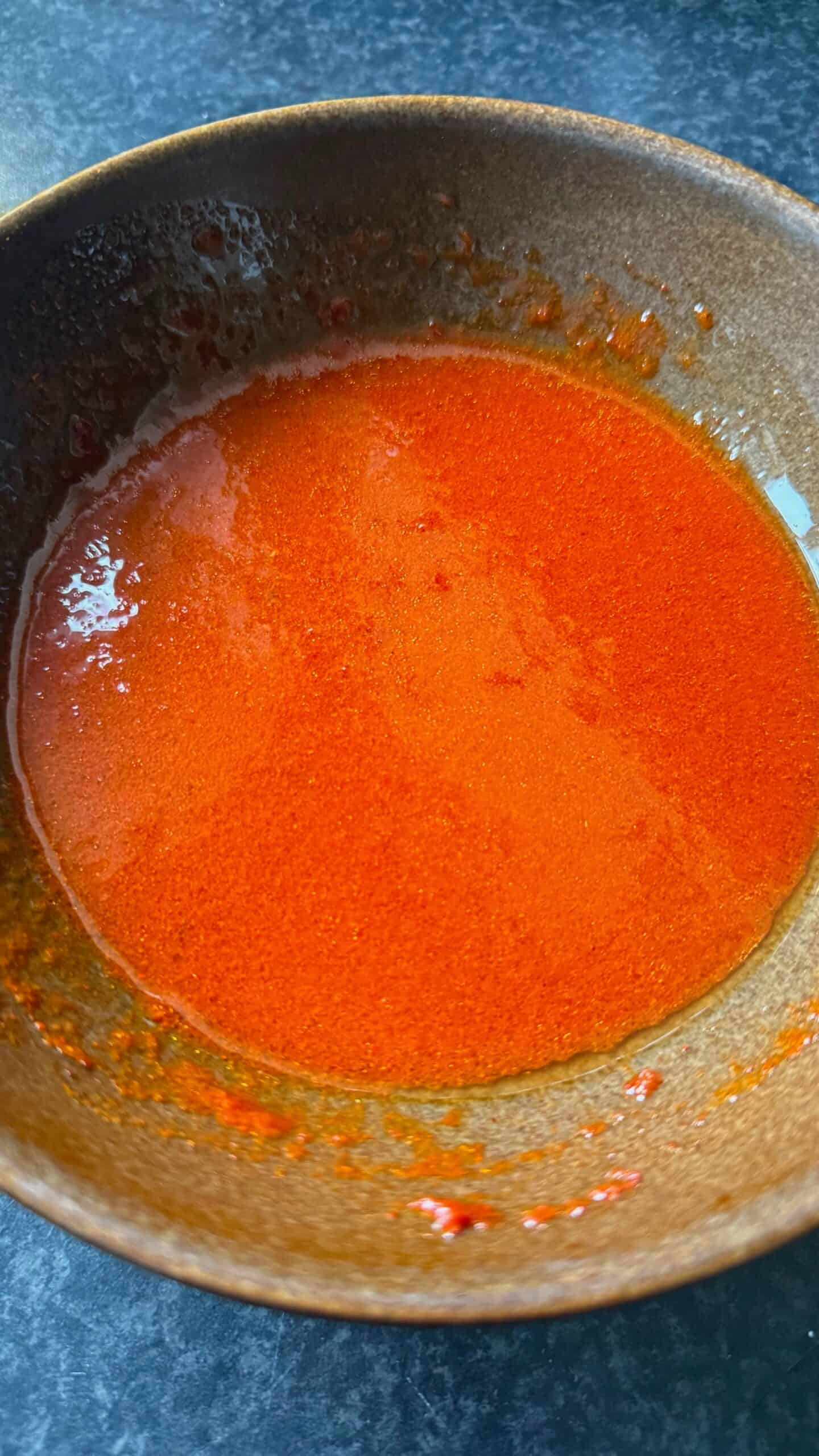 Crispy Chicken Shawarma Wrap with Toum and Pomegranate Molasses Crisping sauce in bowl