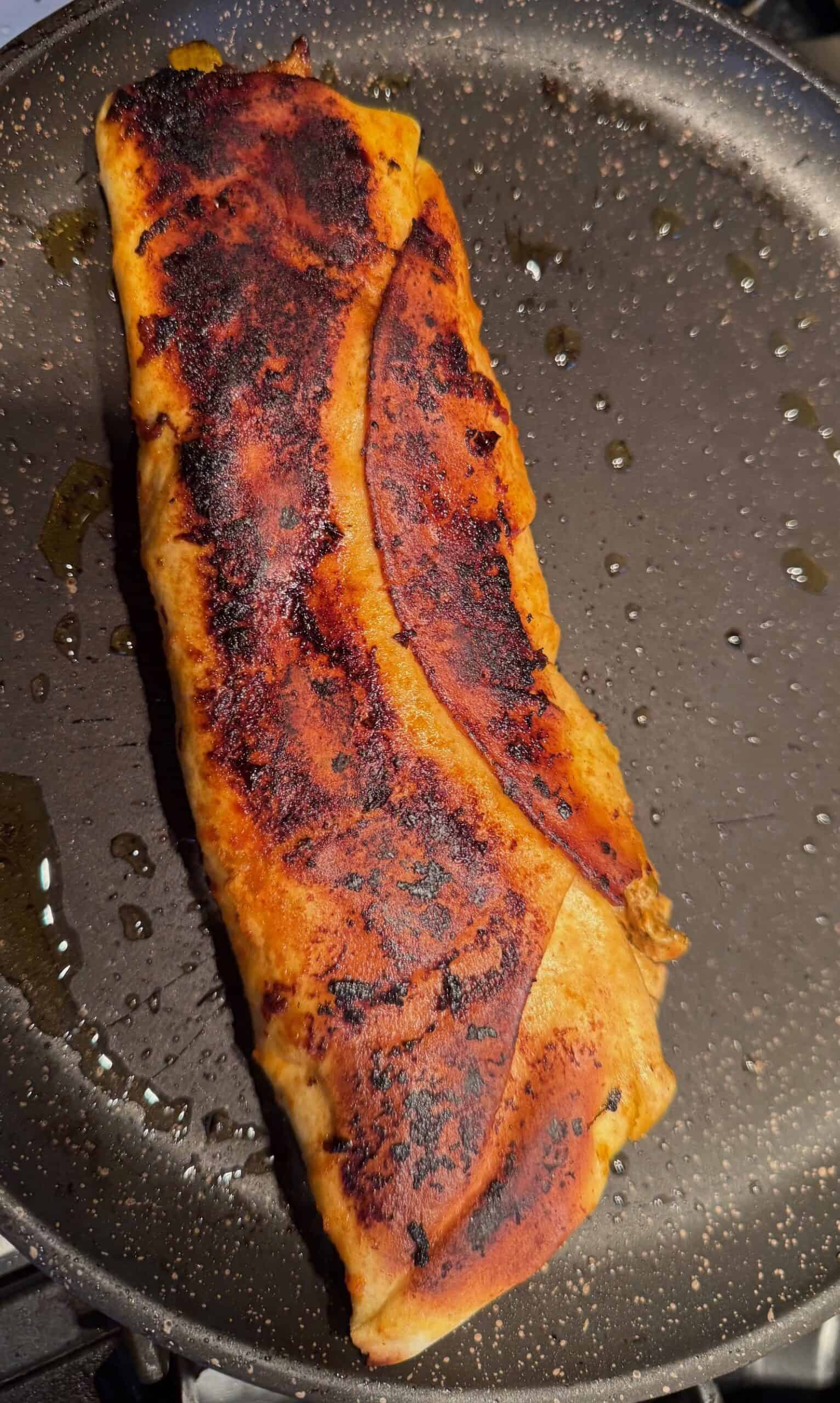 Crispy Chicken Shawarma Wrap with Toum and Pomegranate Molasses Crisped wrap in pan