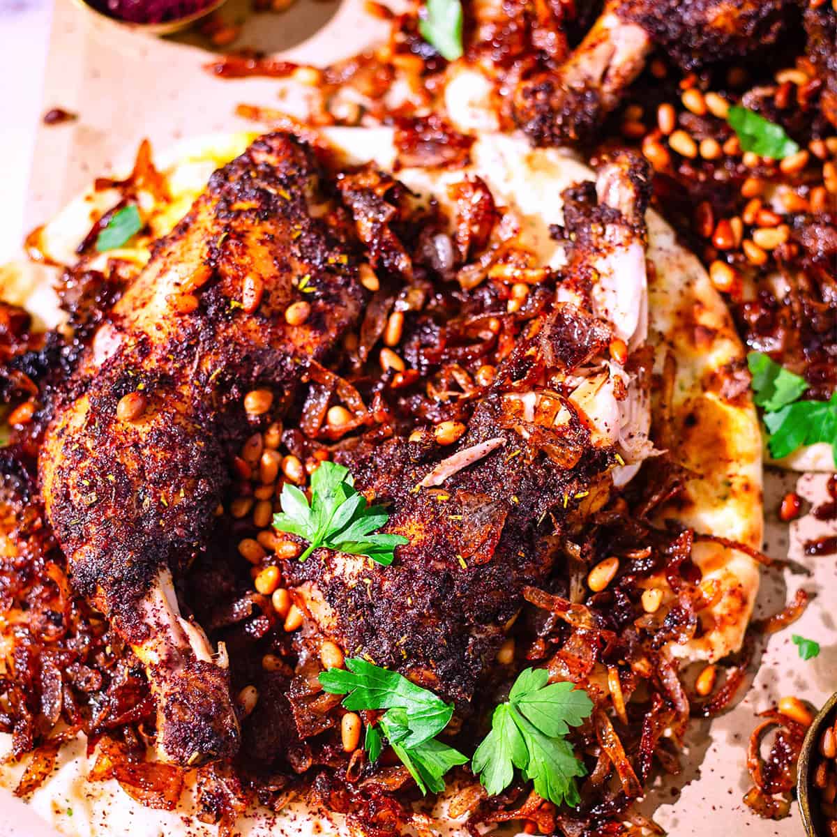 Musakhan (Palestinian Sumac Chicken on Taboon Bread) Musakkan chicken, onions, sumac, pine nuts on dish