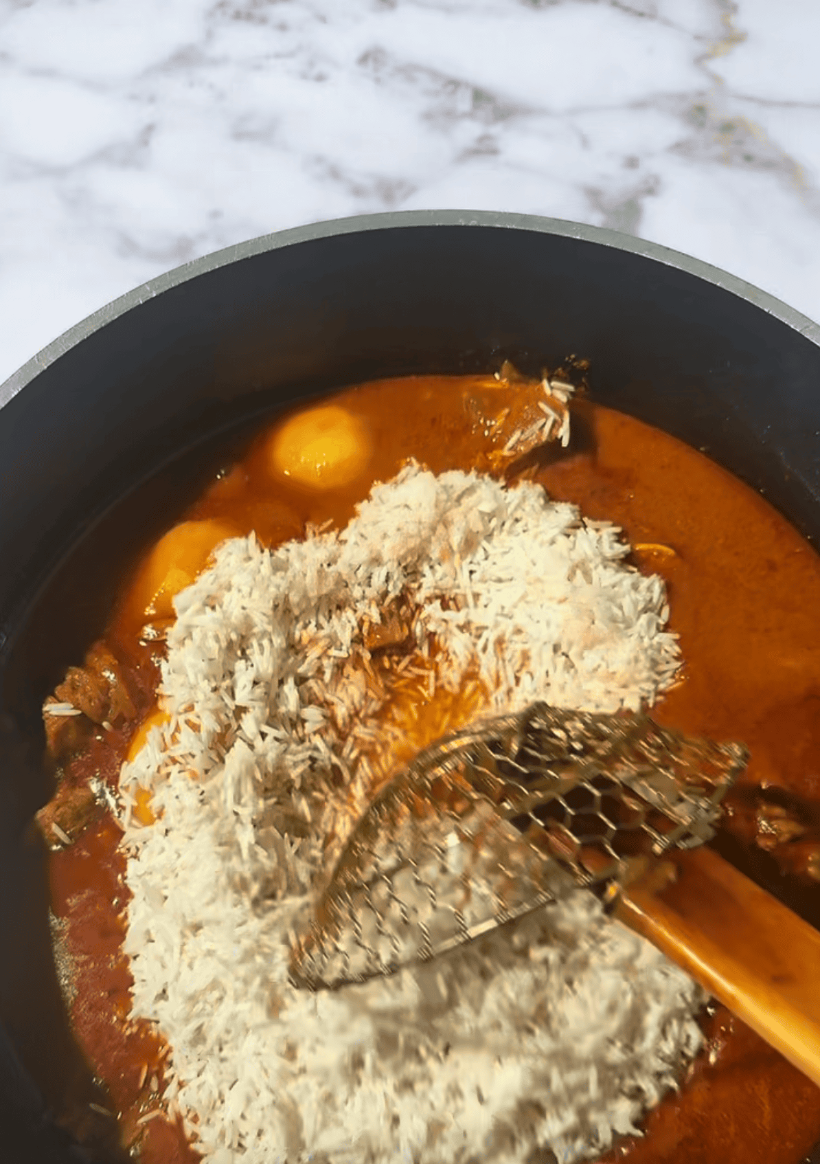 Memon Lamb (or Mutton) Akni Rice being stirred in pot