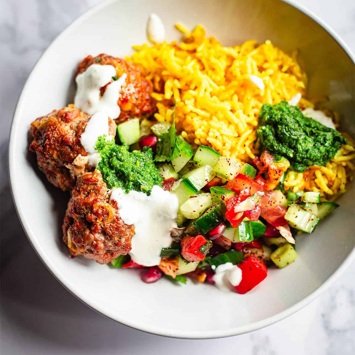Baked Lebanese-Style Kofta Tray Bake (Lamb or Chicken) Kofte with salad and rice in bowl