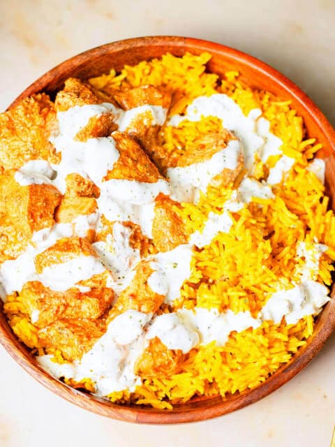Peri chicken, rice and garlic sauce in bowl