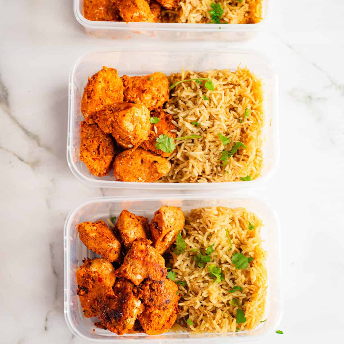 Shish Tawook Meal Prep Bowls with Lebanese Rice Shish Tawook in rice spread over 3 boxes