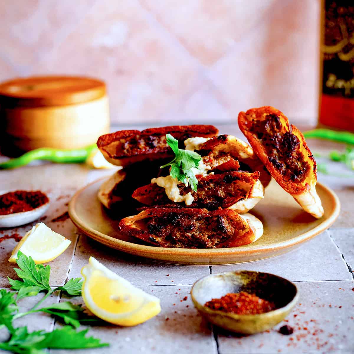 Crispy Lamb Arayes with Tahini Yoghurt Sauce Arayes in a pile on plate