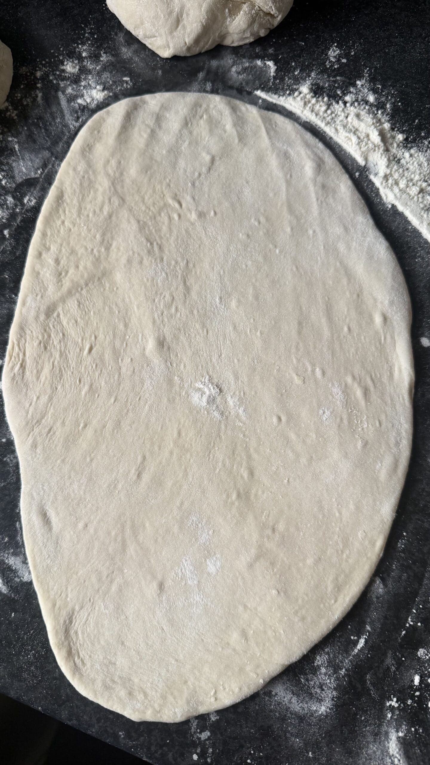 Khachapuri (Georgian Cheese Bread) Dough rolled out on surface