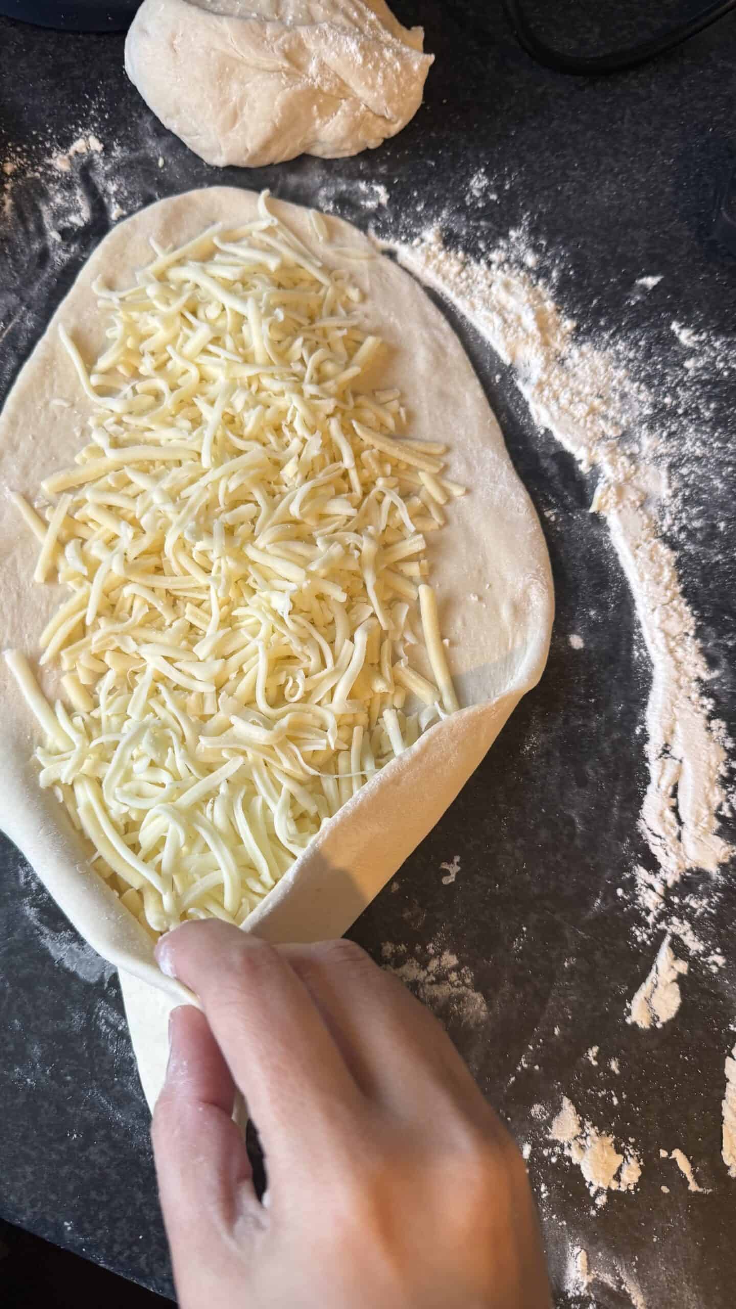 Khachapuri (Georgian Cheese Bread) Dough being closed over dough