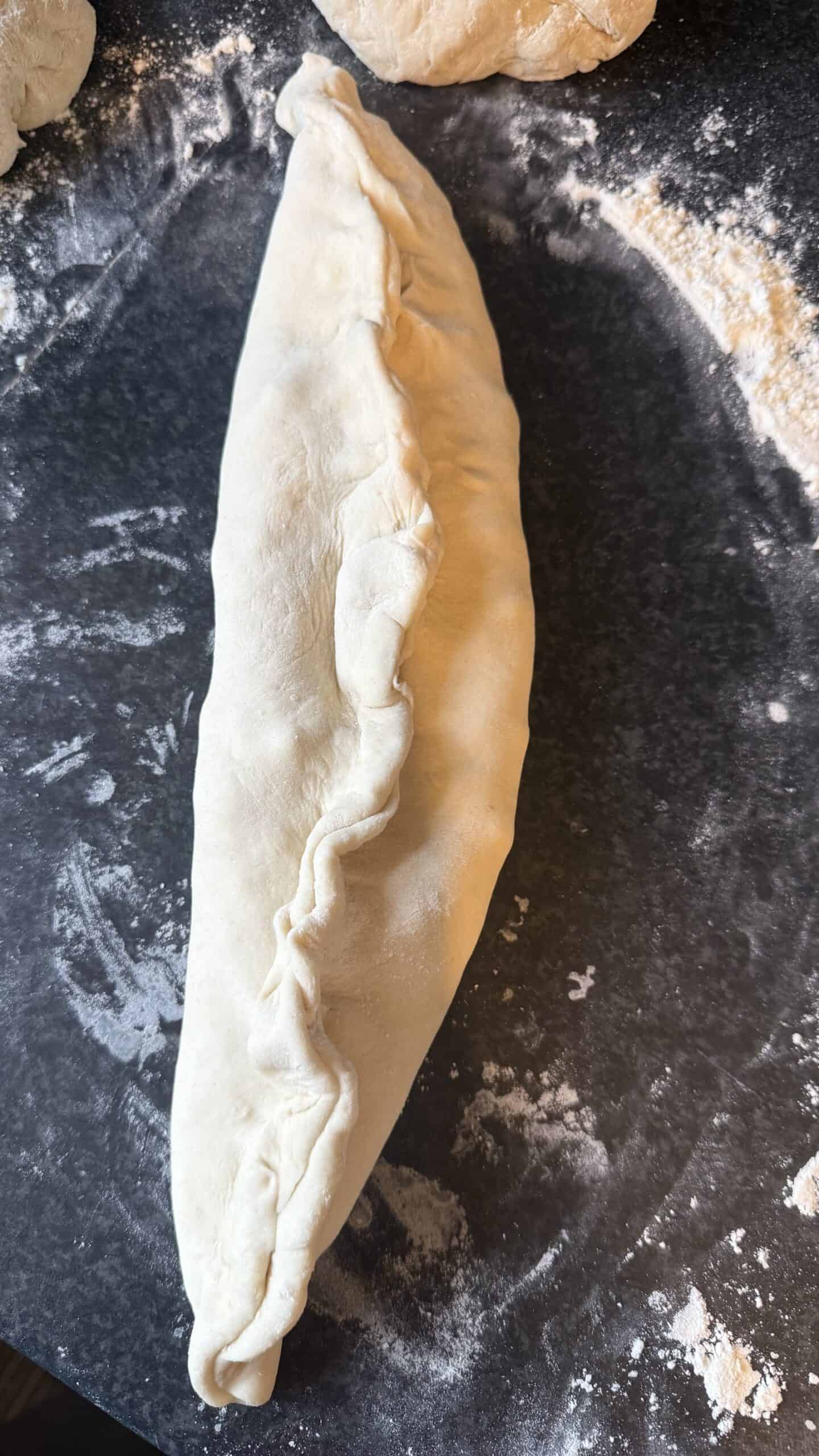 Khachapuri (Georgian Cheese Bread) Sealed dough on table