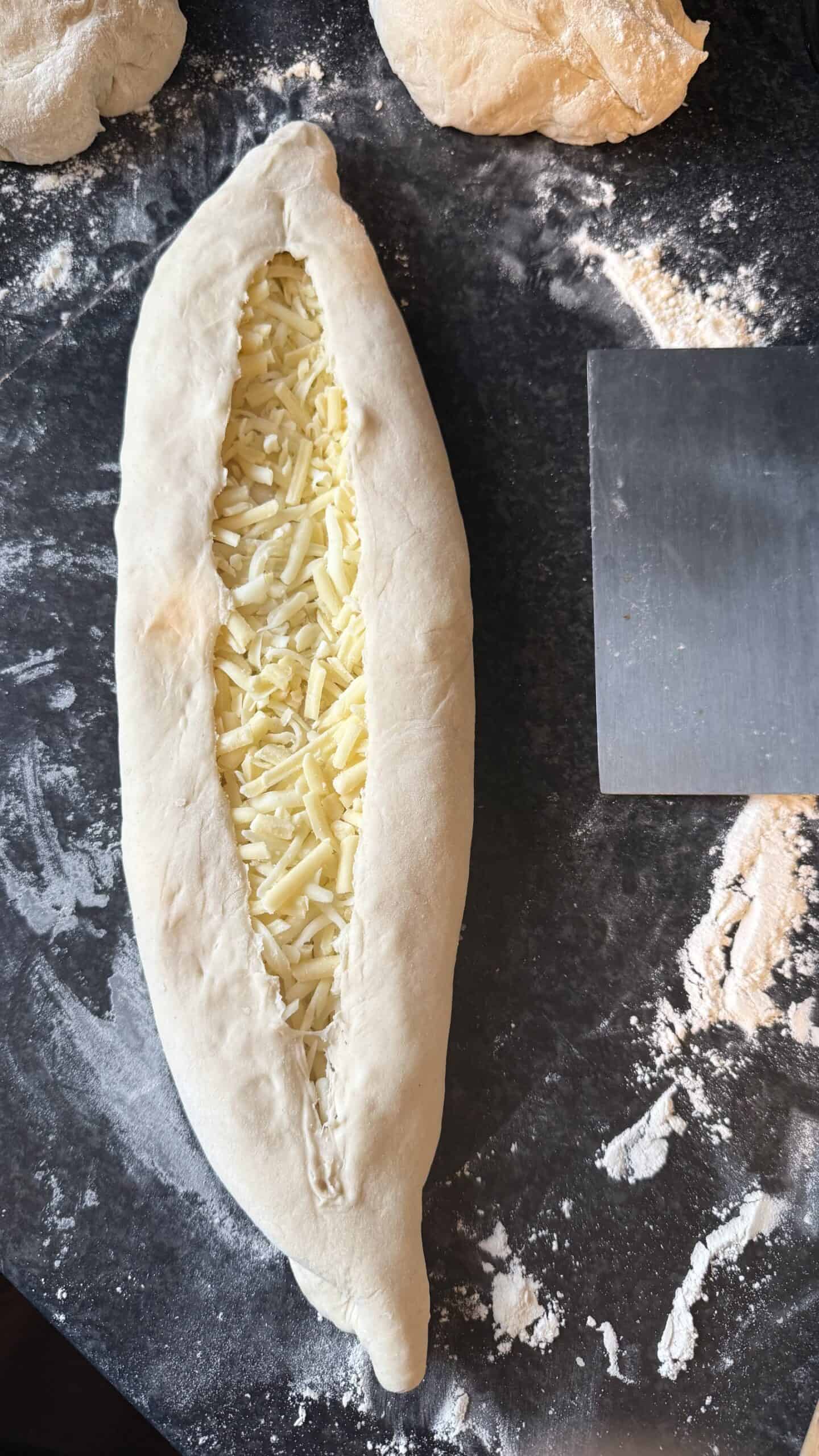 Khachapuri (Georgian Cheese Bread) Kachapuri with cheese filling on table