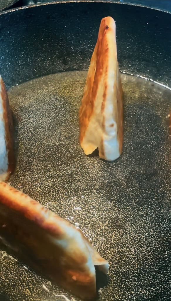 Crispy Lamb Arayes with Tahini Yoghurt Sauce Pitta meat side down in pan