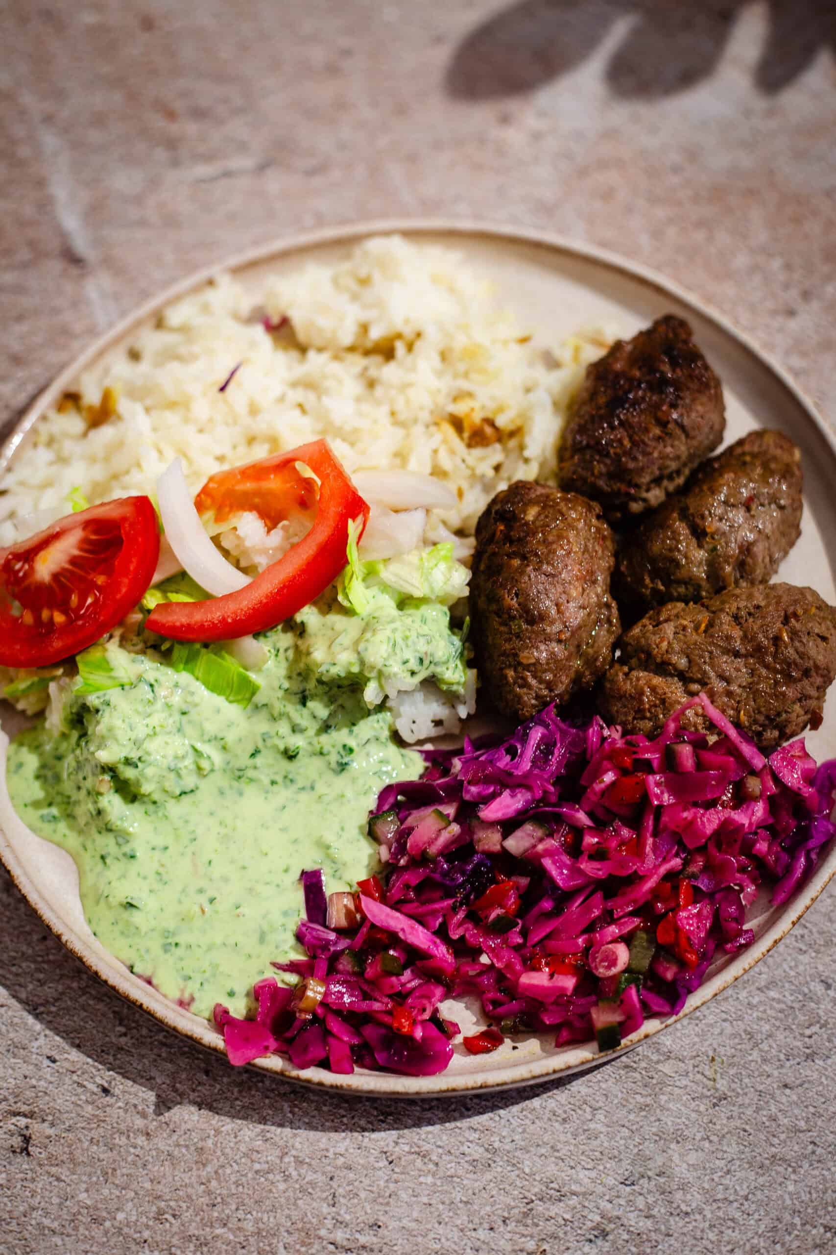 Pakistani Lamb Seekh Kebabs (Restaurant-Style) MIni Seekh Kebab with rice and salad in plate