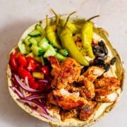 Chicken in a bowl with hummus and salad