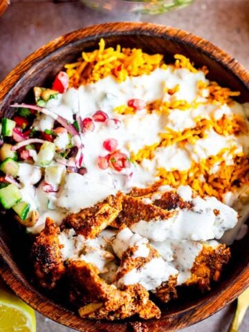 chicken Shawarma, rice, salad and garlic sauce in bowl
