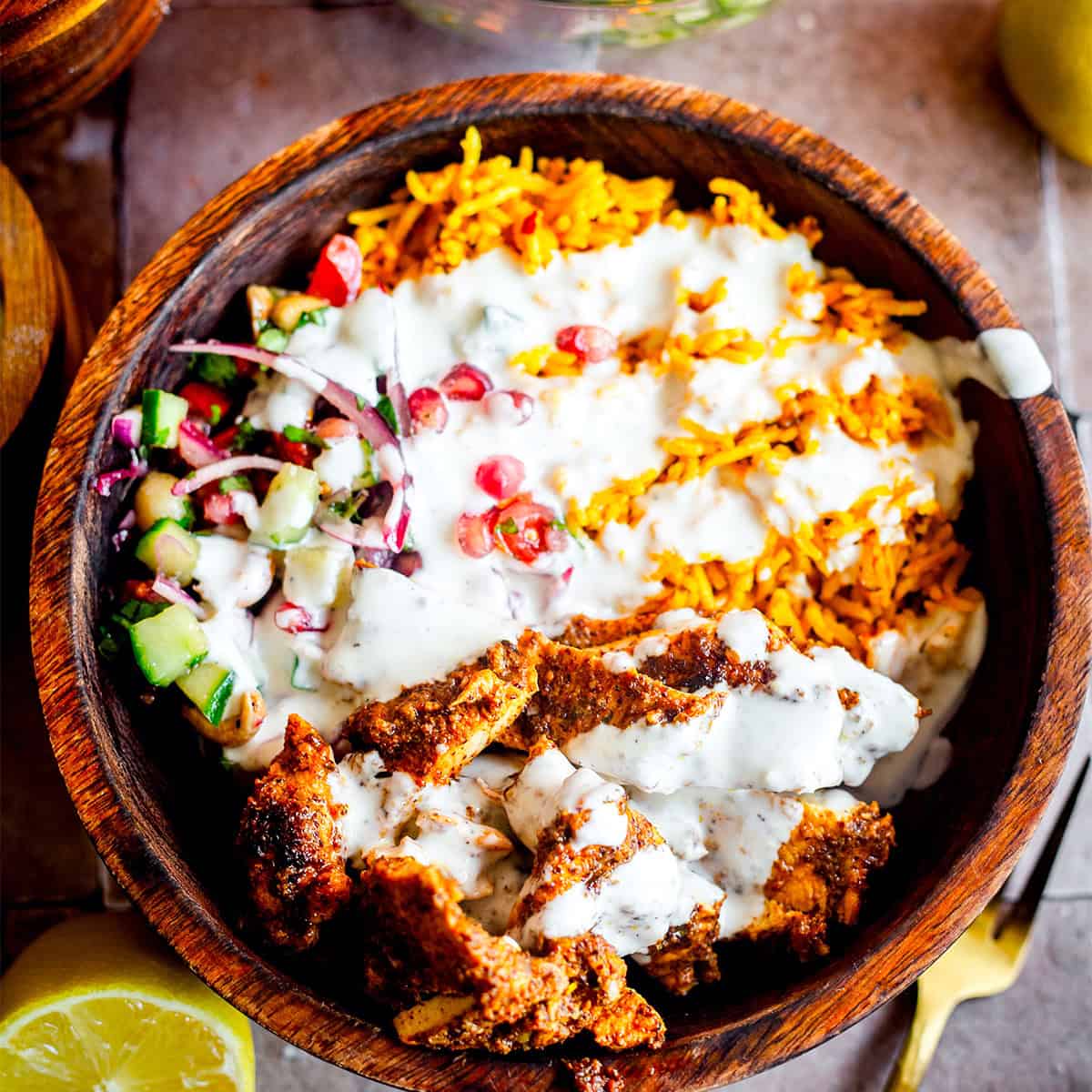 Chicken Shawarma Bowls with Garlic Sauce & Turmeric Rice chicken Shawarma, rice, salad and garlic sauce in bowl