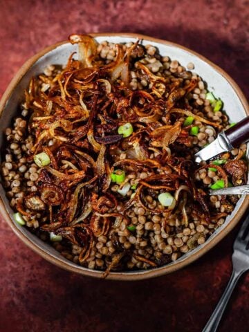Maftoul with crispy onions in bowl