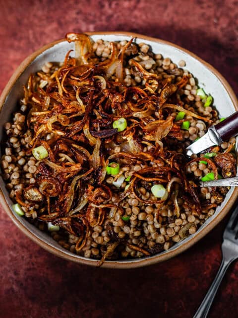 Maftoul with crispy onions in bowl