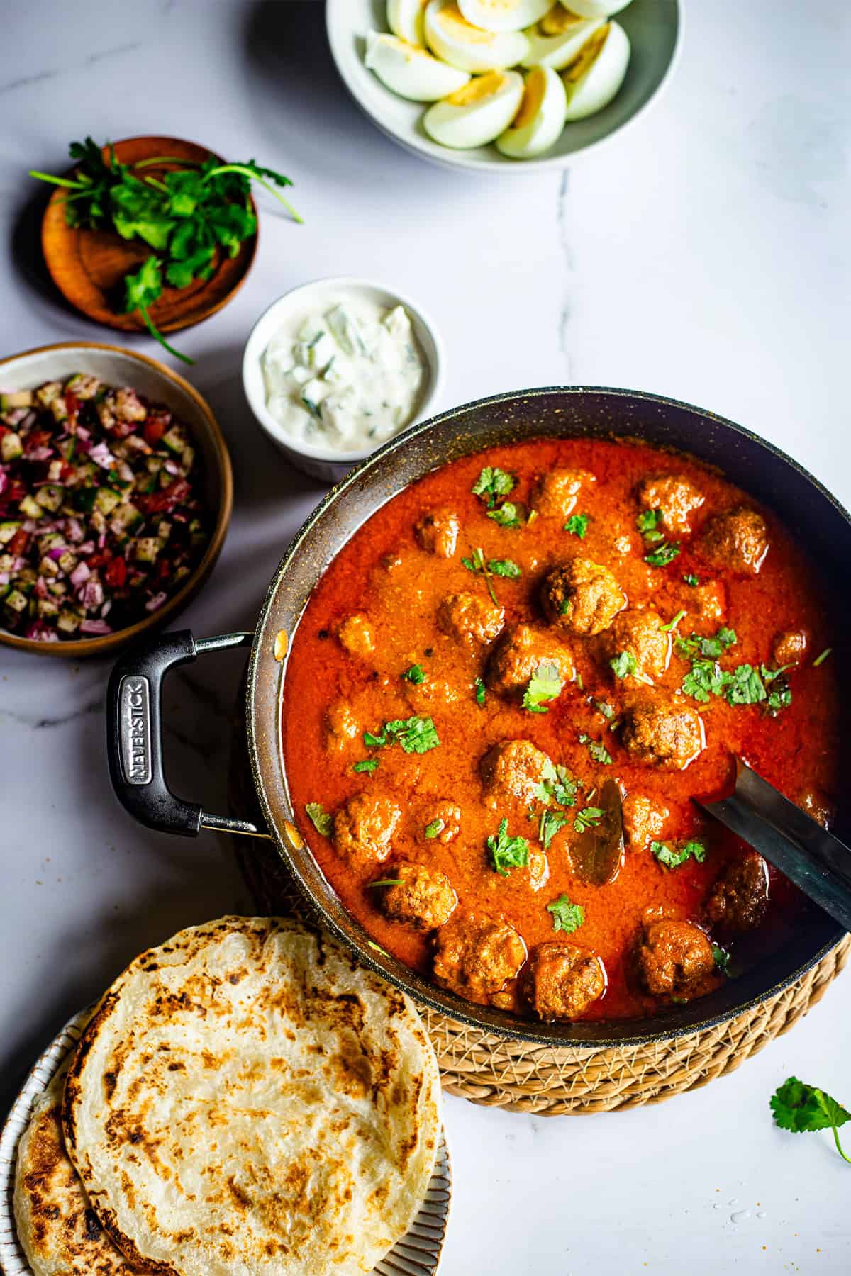 Lamb Kofta Curry (Tender Lamb Meatballs Curry) Kofta curry with salads and chapatti on table