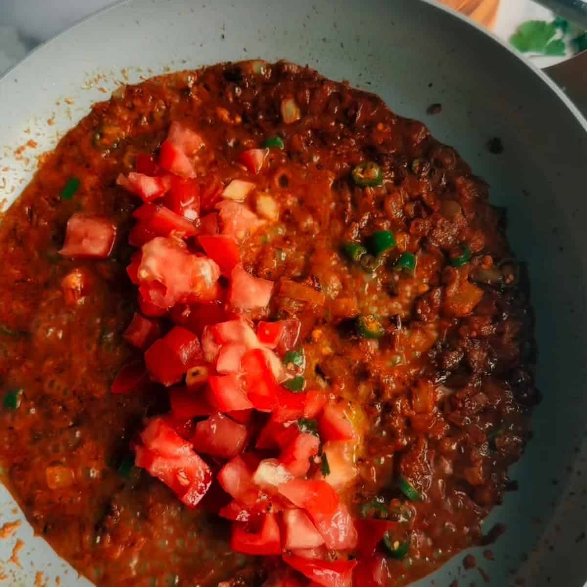 Tomatoes added to pan