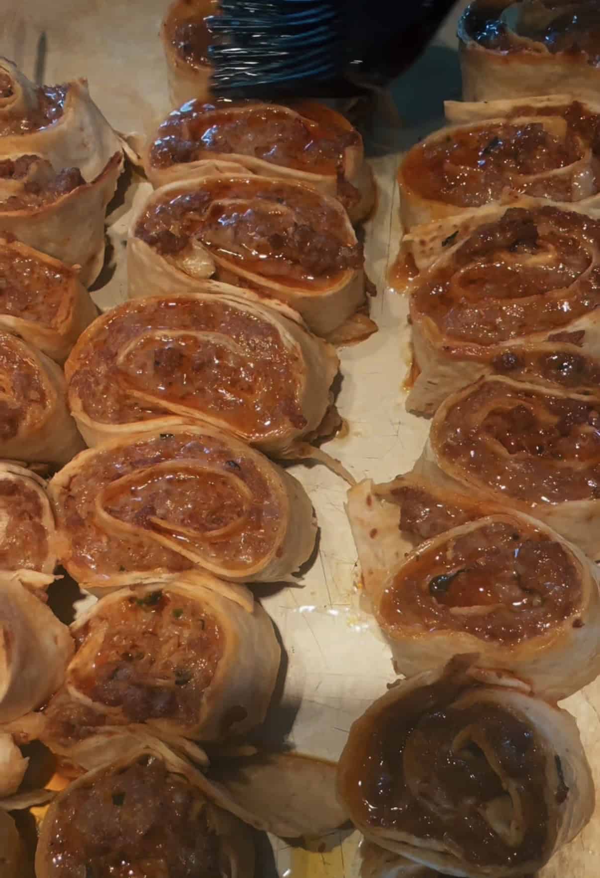 Viral Pinwheel Kebab Wraps Pinwheel kebabs being brushed with butter