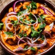 Iffa chicken in dish with coriander garnish