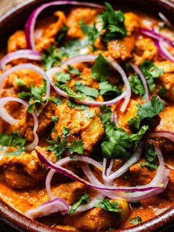 Iffa chicken in dish with coriander garnish