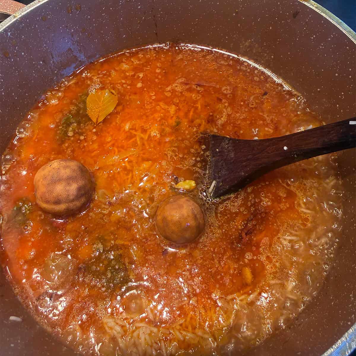 Whole spices and limes added to pot